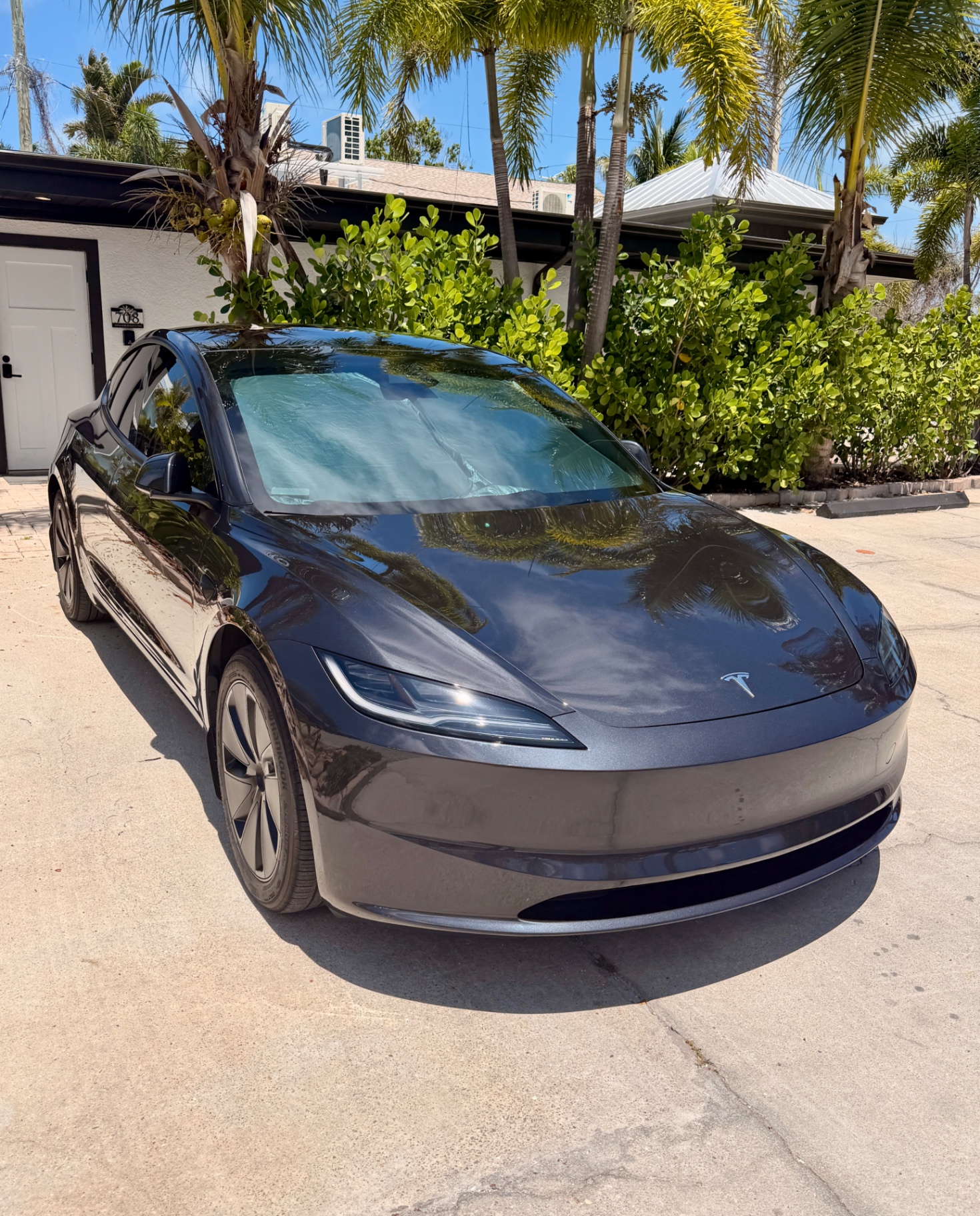 Detailer hand-polishing a luxury car in Bradenton